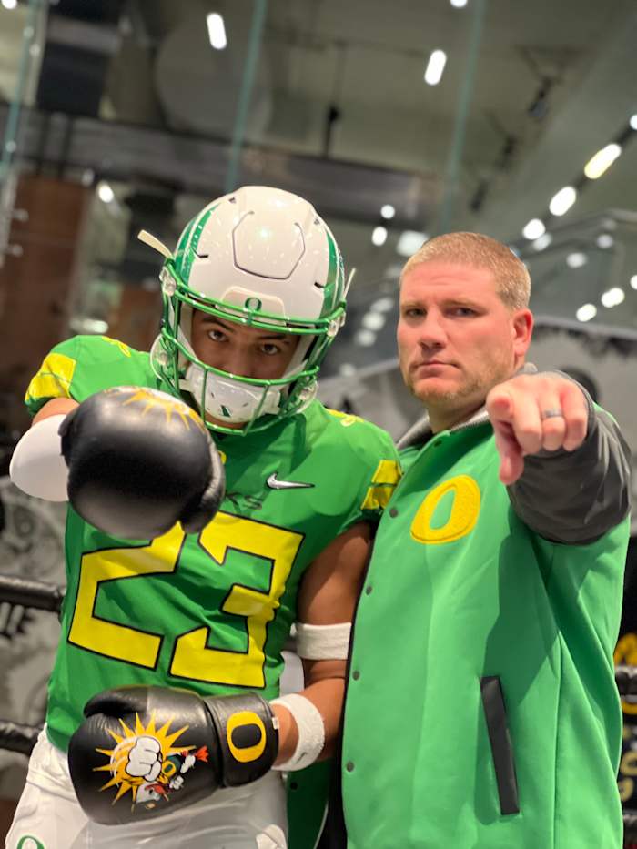 Marco Jones poses with defensive coordinator Tosh Lupoi.